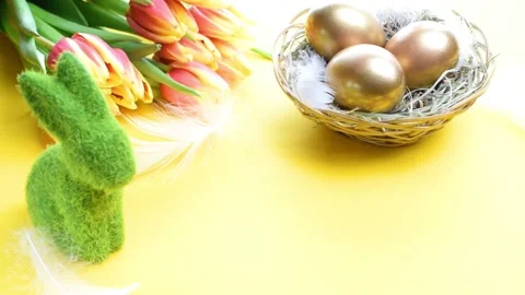 Easter eggs gold. Golden colour egg in basket with spring tulips Stock Footage 147755799