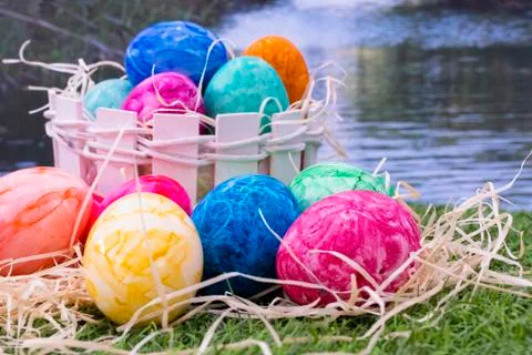 Easter eggs on grass with decorative straw Stock Photos