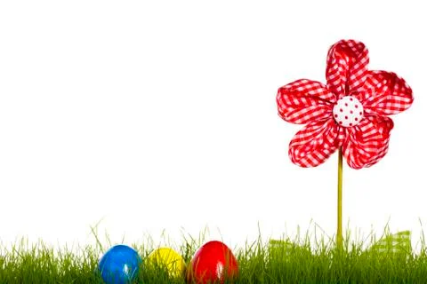 Easter eggs in grass with drapery flower Stock Photos
