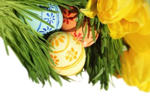 Easter eggs in grass with tulips Stock Photos