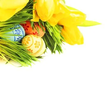 Easter eggs in grass with tulips Stock Photos