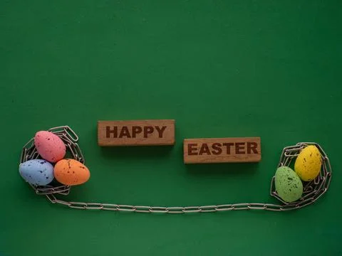 Easter eggs on green background with metal chain Stock Photos