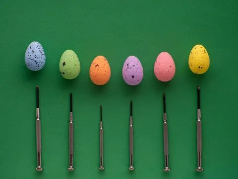 Easter eggs on green background with mini screwdrivers Stock Photos