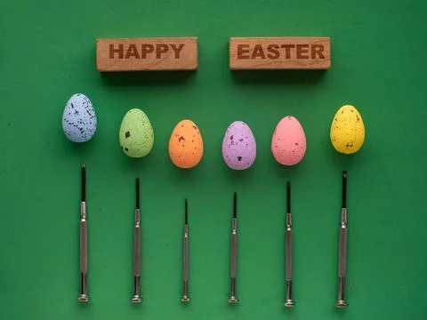 Easter eggs on green background with mini screwdrivers Stock Photos