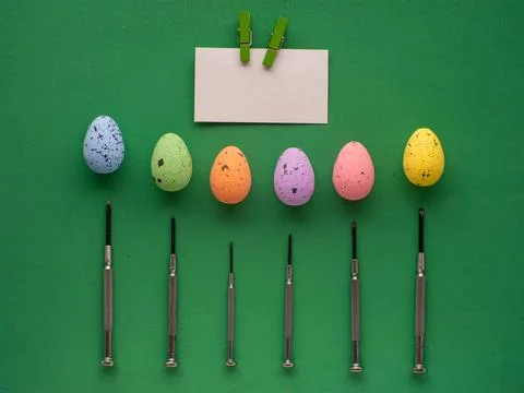 Easter eggs on green background with mini screwdrivers Stock Photos