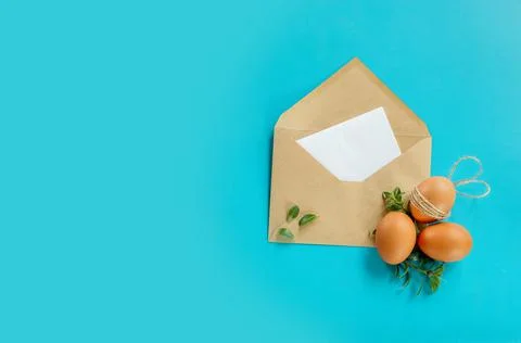 Easter eggs with greenery in an envelope, copy space for text, promo or message Stock Photos
