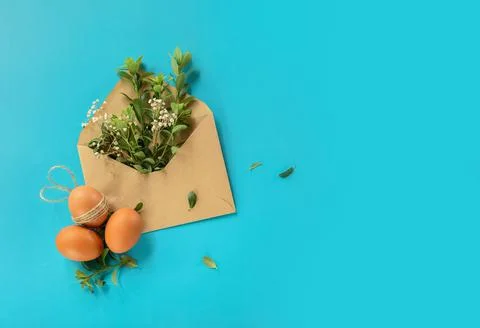 Easter eggs with greenery in an envelope, copy space for text, promo or message Stock Photos