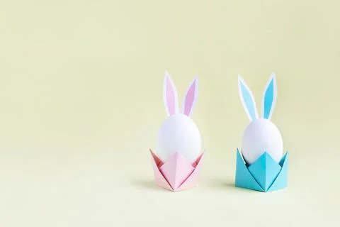 Easter eggs with handmade paper ears on yellow background. Nature concept. Stock Photos