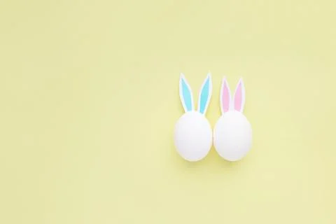 Easter eggs with handmade paper ears on yellow background. Nature concept. Stock Photos
