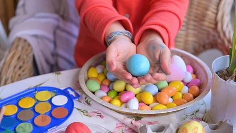 Easter eggs in the hands of children's hands. Large and small eggs of different Stock Footage 126713093