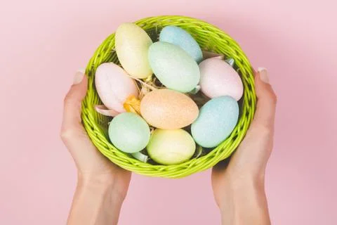 Easter eggs in the hands isolated on pink background Stock Photos