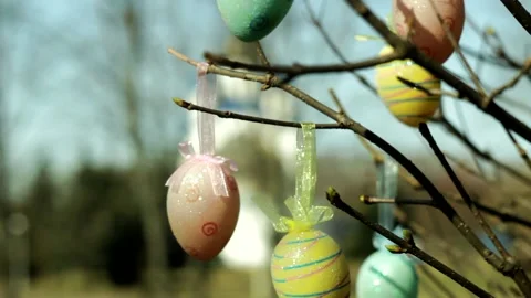 Easter eggs hang on branches near an Orthodox church. Stock Footage 235164962