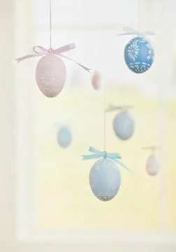 Easter eggs hanging by string Stock Photos