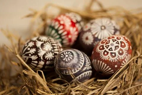Easter eggs in hay nest Stock Photos