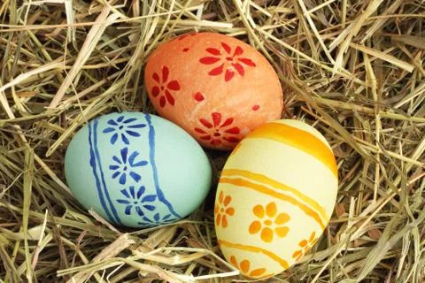 Easter eggs on hay Stock Photos