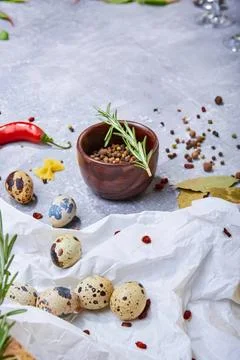 Easter eggs, herbs, and spices on white cloth background Stock Photos