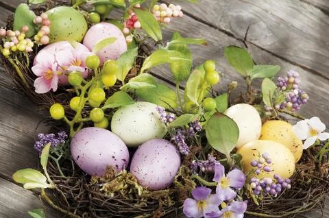 Easter eggs hidden in natural straw nest Stock Photos