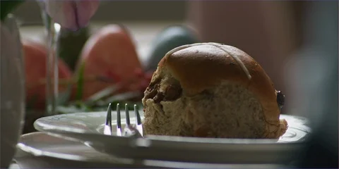 Easter eggs &amp; hot cross buns on table in daylight Video stock 106223766