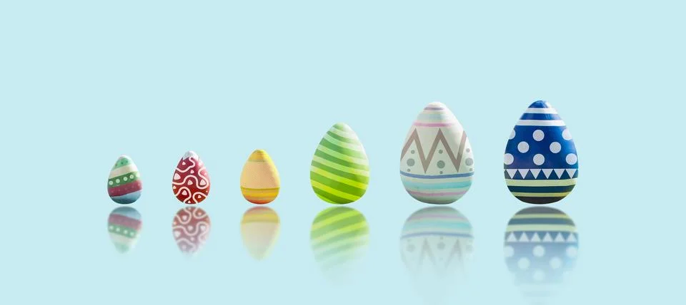 Easter eggs isolated is painted in different patterns on blue background 库存照片