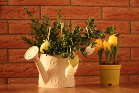 Easter eggs in jug with tulips Stock Photos