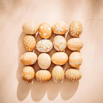 Easter eggs laid out squared on clay textured background Stock Photos