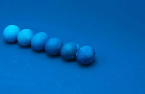 Easter eggs layout on blue background. ombre effect. classic blue monochromat Stock Photos