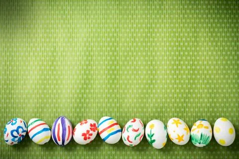 Easter eggs lie on a green background Stock Photos