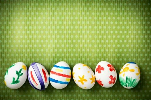 Easter eggs lie on a green background Stock Photos