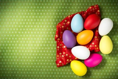 Easter eggs lie on a green background Stock Photos
