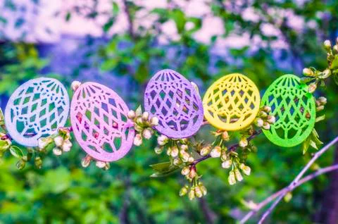 Easter eggs made of colored felt with flowering branches of fruit tree. Stock Photos