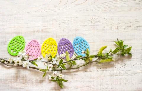 Easter eggs made of colored felt with flowering branches of fruit tree. Stock Photos