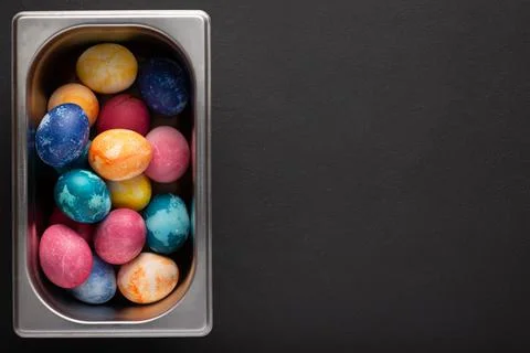 Easter eggs in a metal container close up on a black background Foto stock