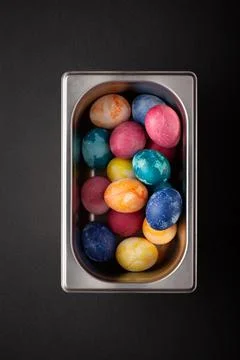 Easter eggs in a metal container close up on a black background Foto stock