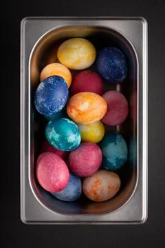 Easter eggs in a metal container close up on a black background Stock Photos