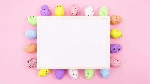 Easter eggs move around frame for text on pastel pink theme. Stop motion Stock Footage 147730350