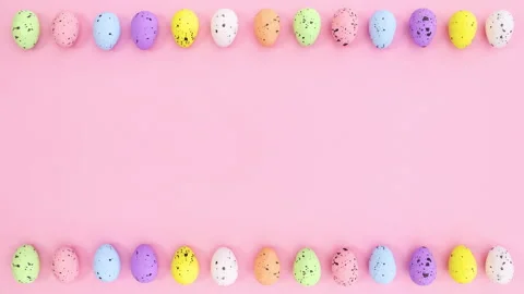 Easter eggs move left right on top and bottom of pink theme. Stop motion Stock Footage 148781466