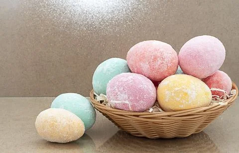 Easter eggs multi-colored in a basket on a wooden background, copy space. bok Stock Photos