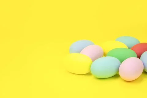 Easter eggs, multicolored on a yellow background with space for text. Stock Photos