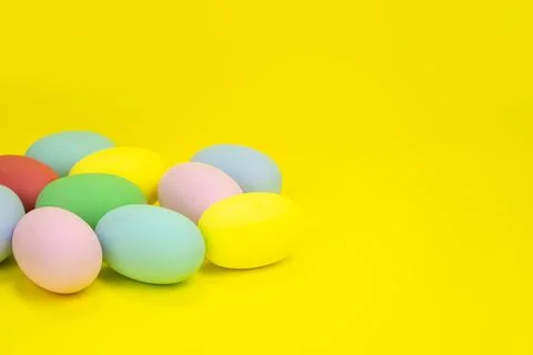 Easter eggs, multicolored on a yellow background with space for text. Stock Photos