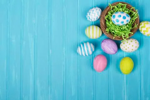 Easter eggs in nest on blue background Stock Photos