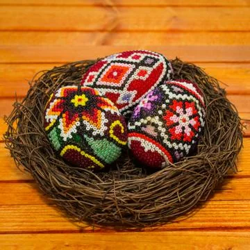 Easter eggs in a nest, close view. Traditional romanian decorated easter eggs. Stock Photos