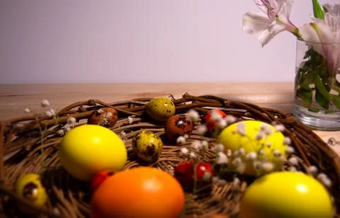 Easter eggs in a nest with flowers Stock Photos