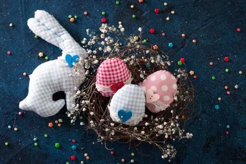 Easter eggs in the nest on rustic dark blue background Stock Photos