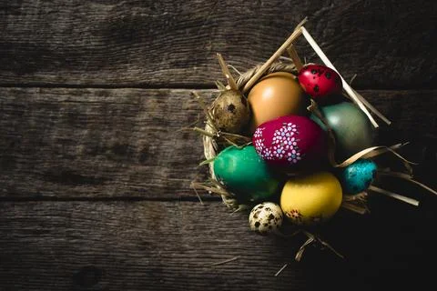Easter eggs in nest on rustic wooden planks Stock Photos