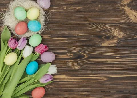 Easter eggs nest with tulips table Stock Photos
