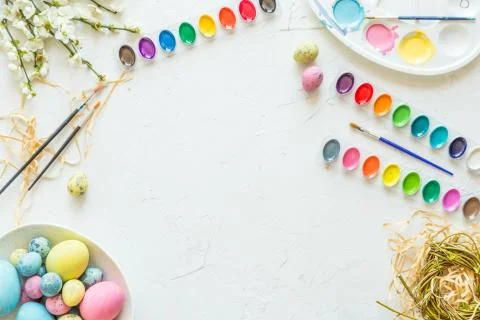 Easter eggs, paint and brushes. Holiday concept. Flat lay. Top view. Place for Stock Photos