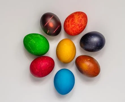 Easter eggs painted in different colors, on a white background, top view Stock Photos
