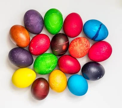 Easter eggs painted in different colors, on a white background, top view Stock Photos