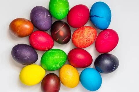 Easter eggs painted in different colors, on a white background, top view Stock Photos