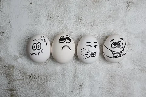 Easter eggs with painted funny faces wearing mask for Easter holidays Stock Photos